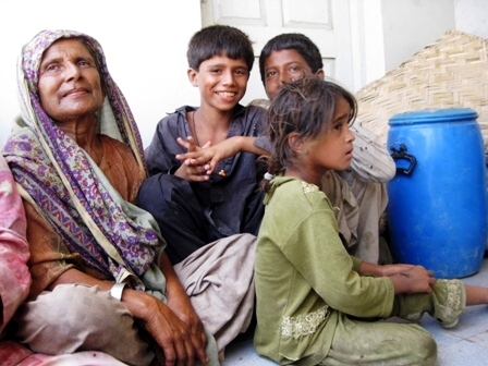 flooded road in Pakistan, humans starve, no drinking water, no food